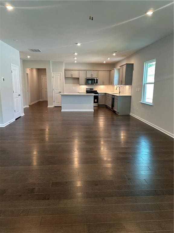 861 Pineberry Ct, Grayson, GA 30017 - kitchen with appliances with stainless steel finishes, gray cabinetry, light countertops, dark wood-type flooring, and recessed lighting