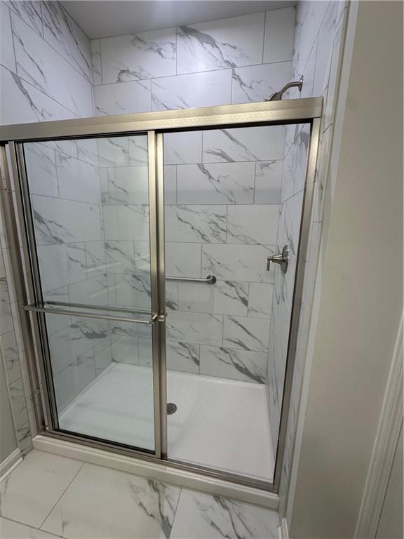 861 Pineberry Ct, Grayson, GA 30017 - full bath with marble finish floors and a stall shower