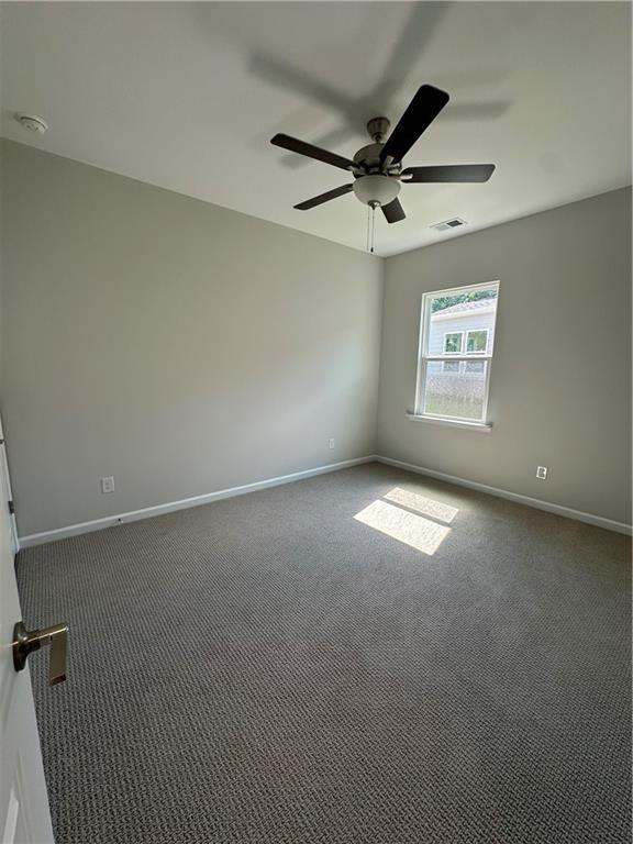 861 Pineberry Ct, Grayson, GA 30017 - spare room with ceiling fan and carpet floors