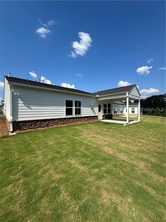 861 Pineberry Ct, Grayson, GA 30017 - back of house featuring a yard, a carport, and a patio