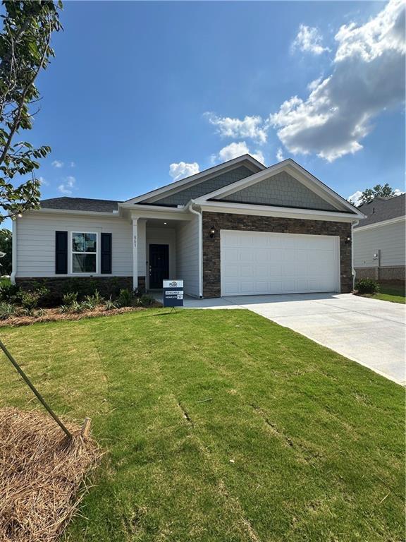 861 Pineberry Ct, Grayson, GA 30017 - ranch-style home featuring driveway, a garage, a front yard, and stone siding