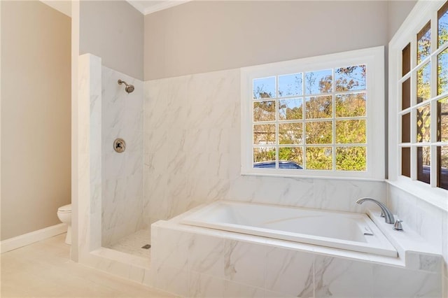 bathroom with toilet, a garden tub, a marble finish shower, and baseboards