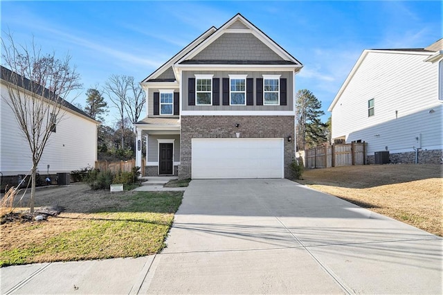 view of front of property with central AC unit, a front yard, and a garage