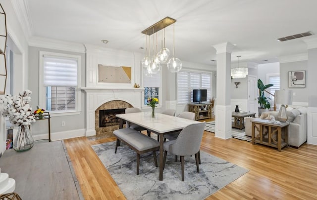 dining room with crown molding and light hardwood / wood-style floors