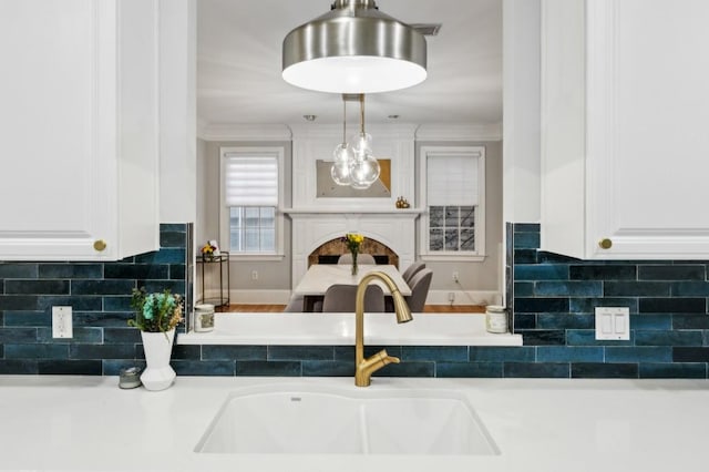 kitchen featuring white cabinetry, sink, and decorative backsplash