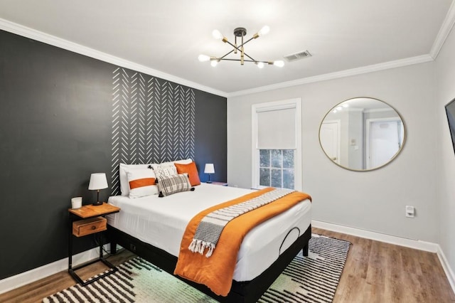 bedroom featuring a notable chandelier, crown molding, and wood-type flooring