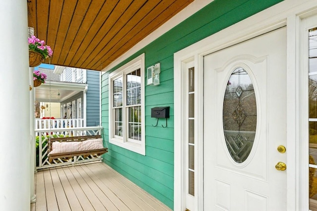 view of exterior entry with covered porch