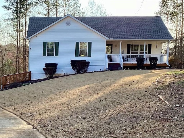 single story home featuring a porch and a shingled roof