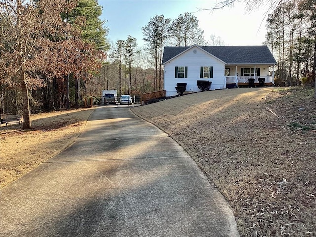 ranch-style home with covered porch and driveway