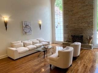 4340 Candacraig, Johns Creek, GA 30022 - living room with wood finished floors, baseboards, and a large fireplace