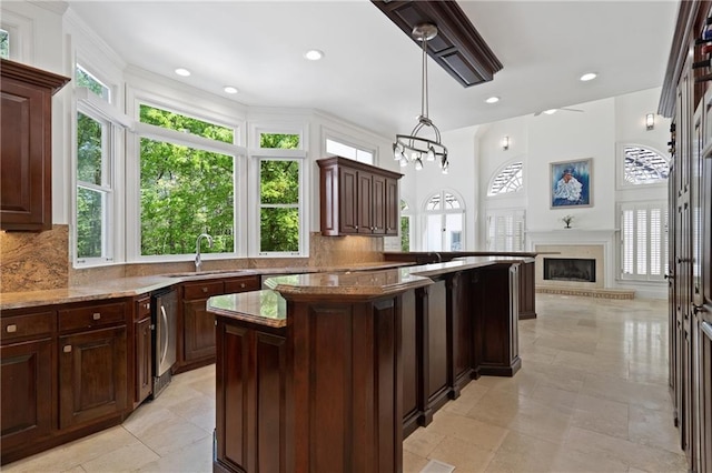 4340 Candacraig, Johns Creek, GA 30022 - kitchen featuring a sink, tasteful backsplash, light stone countertops, a center island, and recessed lighting