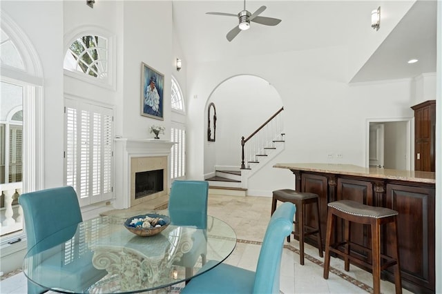 4340 Candacraig, Johns Creek, GA 30022 - dining room with stairway, high vaulted ceiling, inlaid floor details, ceiling fan, and a fireplace