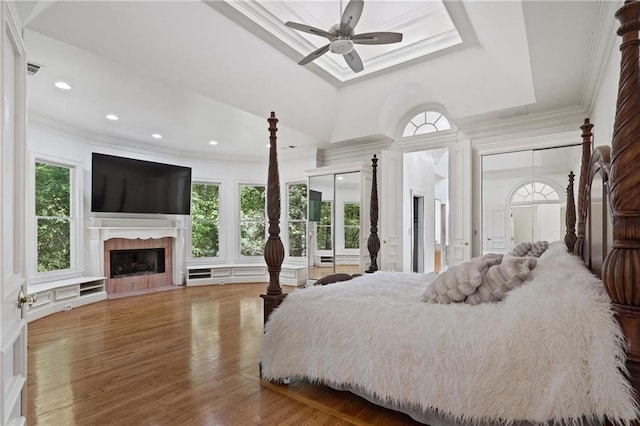 4340 Candacraig, Johns Creek, GA 30022 - bedroom featuring crown molding, multiple windows, a fireplace with flush hearth, wood finished floors, and a decorative wall