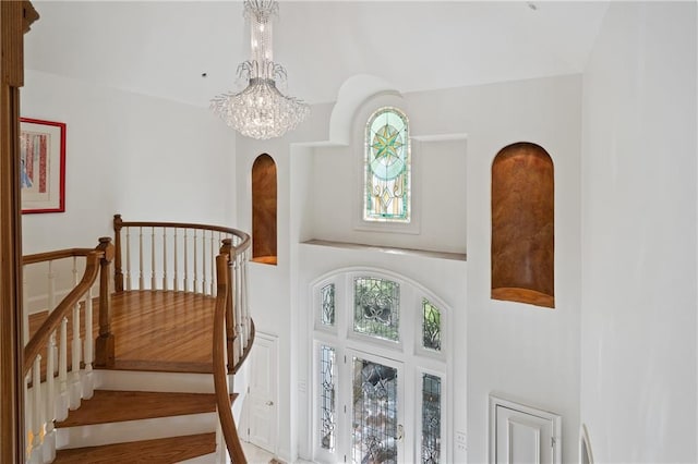 4340 Candacraig, Johns Creek, GA 30022 - staircase featuring a chandelier, healthy amount of natural light, and arched walkways