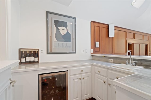 4340 Candacraig, Johns Creek, GA 30022 - kitchen with beverage cooler, a sink, light countertops, and white cabinetry