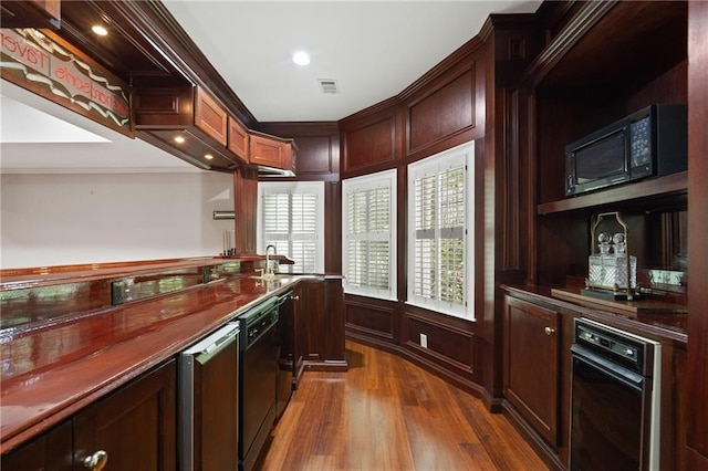4340 Candacraig, Johns Creek, GA 30022 - kitchen featuring black appliances, crown molding, dark countertops, dark wood-style floors, and a decorative wall