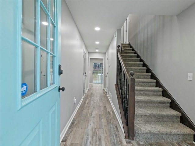 staircase featuring hardwood / wood-style floors