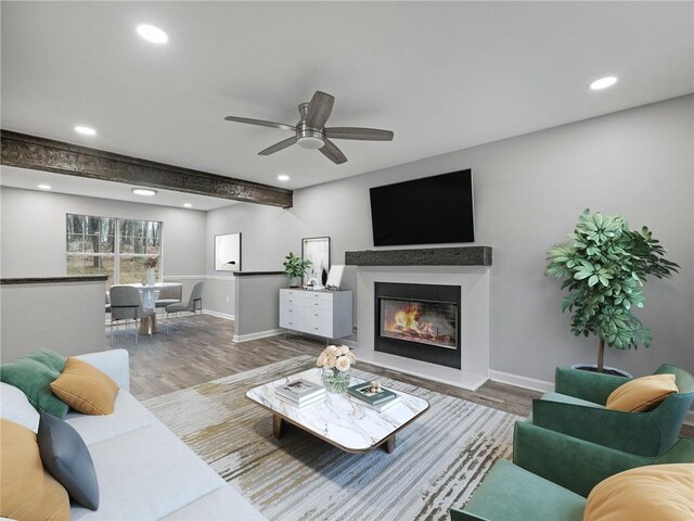 unfurnished living room with ceiling fan, hardwood / wood-style floors, and beam ceiling