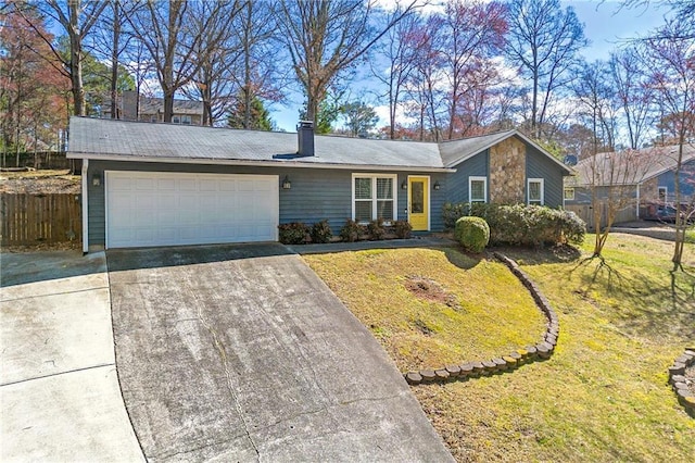 view of front facade with an attached garage, driveway, fence, and a front lawn