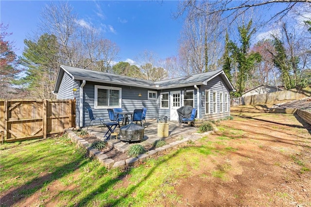 back of property with a patio area and a fenced backyard