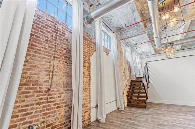 interior space with brick wall and wood finished floors