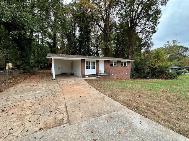 view of front of house with a front yard and a carport