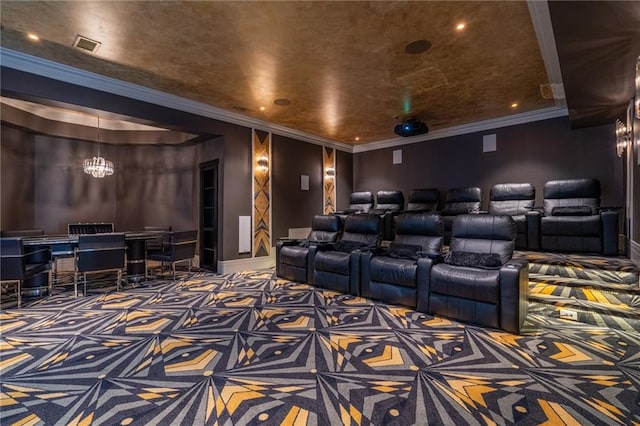 carpeted home theater room with ornamental molding and a notable chandelier