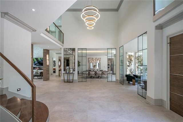 interior space with french doors, ornamental molding, and a notable chandelier