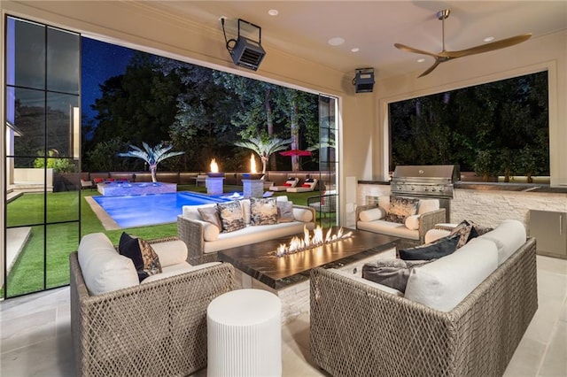 view of patio with an outdoor kitchen, ceiling fan, and grilling area