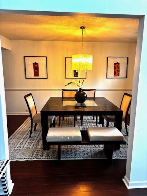 7178 Glaspie Way, Atlanta, GA 30349 - dining room with hardwood / wood-style floors, a chandelier, and a textured ceiling