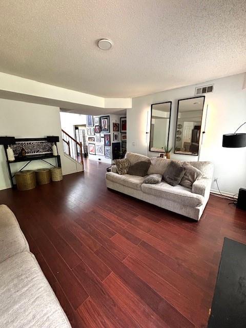 7178 Glaspie Way, Atlanta, GA 30349 - living area with wood finished floors, stairs, and a textured ceiling