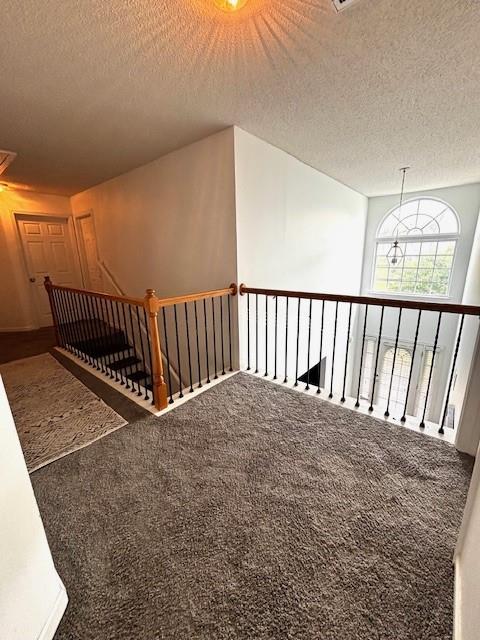 7178 Glaspie Way, Atlanta, GA 30349 - stairs featuring carpet flooring and a textured ceiling
