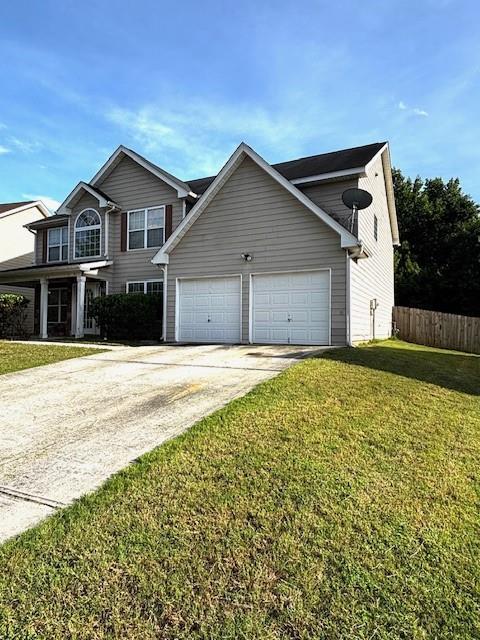 7178 Glaspie Way, Atlanta, GA 30349 - view of home's exterior with a garage and driveway