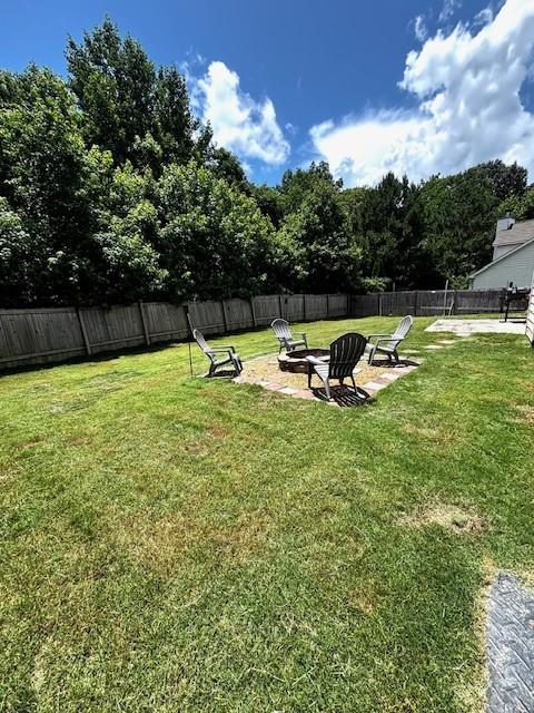 7178 Glaspie Way, Atlanta, GA 30349 - fenced backyard featuring an outdoor fire pit
