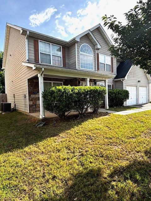 7178 Glaspie Way, Atlanta, GA 30349 - view of front of property with a front lawn and a garage