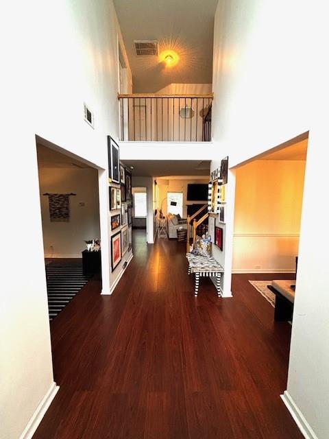 7178 Glaspie Way, Atlanta, GA 30349 - corridor featuring a towering ceiling and wood finished floors