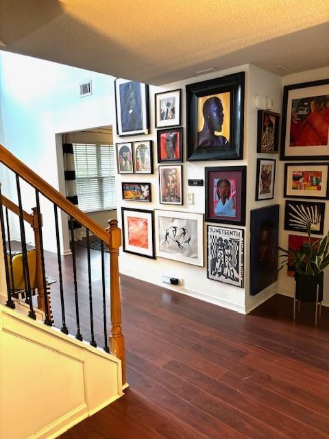 7178 Glaspie Way, Atlanta, GA 30349 - staircase with hardwood / wood-style flooring and a textured ceiling