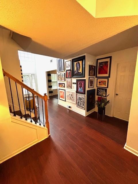 7178 Glaspie Way, Atlanta, GA 30349 - hallway featuring wood finished floors and stairs