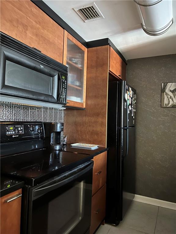 kitchen with black appliances and tile patterned flooring