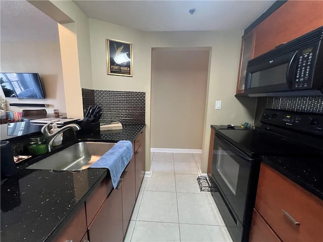 kitchen featuring black appliances, light tile patterned flooring, sink, and dark stone counters