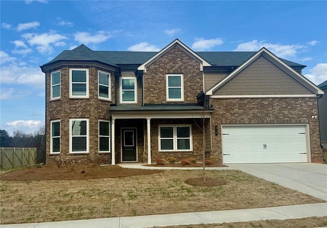 view of front facade with a porch, an attached garage, brick siding, fence, and driveway