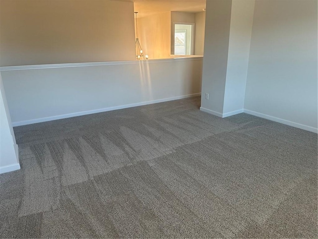 empty room with carpet floors and baseboards