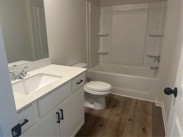 full bath with toilet, shower / bathtub combination, wood finished floors, and vanity