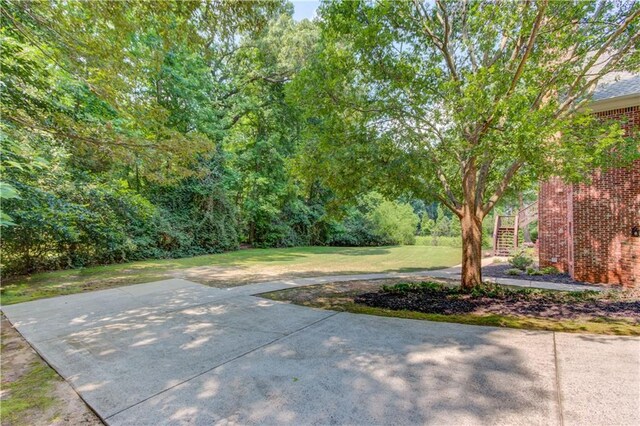 1485 Rolling Links Dr, Alpharetta, GA 30004 - view of grassy yard featuring stairs and a patio