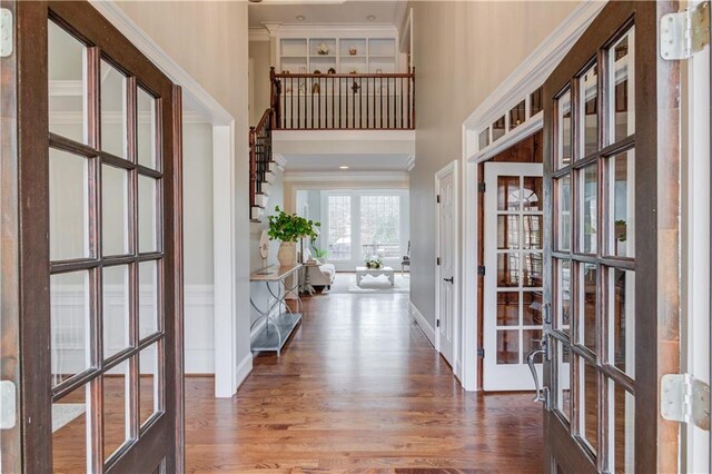 1485 Rolling Links Dr, Alpharetta, GA 30004 - entrance foyer featuring wood finished floors, french doors, crown molding, a towering ceiling, and baseboards