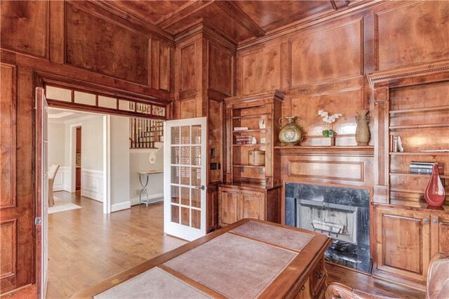 1485 Rolling Links Dr, Alpharetta, GA 30004 - home office featuring a fireplace, wood finished floors, a decorative wall, wood walls, and wooden ceiling