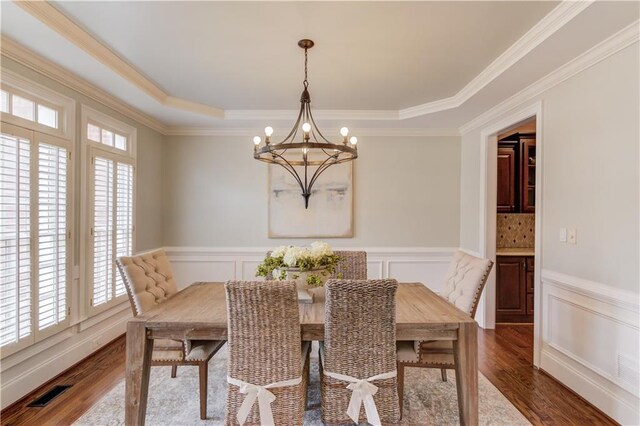 1485 Rolling Links Dr, Alpharetta, GA 30004 - dining space featuring healthy amount of natural light, a chandelier, a decorative wall, ornamental molding, and a wainscoted wall