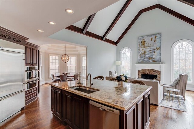 1485 Rolling Links Dr, Alpharetta, GA 30004 - kitchen with appliances with stainless steel finishes, a sink, a chandelier, a stone fireplace, and dark wood-style floors