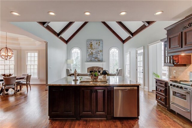 1485 Rolling Links Dr, Alpharetta, GA 30004 - kitchen with appliances with stainless steel finishes, a sink, a chandelier, a stone fireplace, and dark wood-style floors