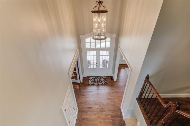 1485 Rolling Links Dr, Alpharetta, GA 30004 - entrance foyer with a high ceiling, wood finished floors, stairway, a chandelier, and baseboards